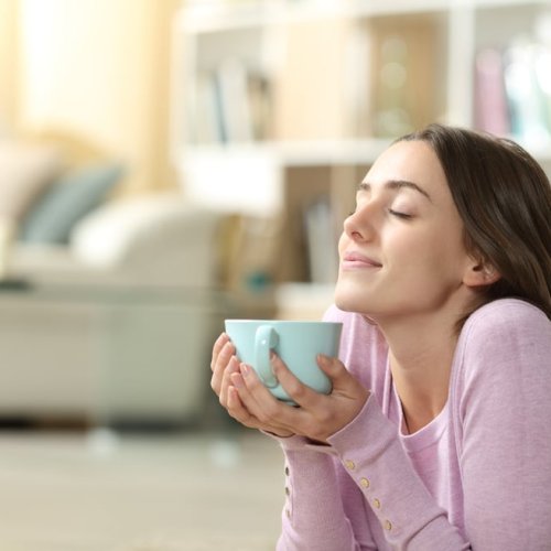 Kvinne nyter en kopp te med nytt liv etter neseoperasjon